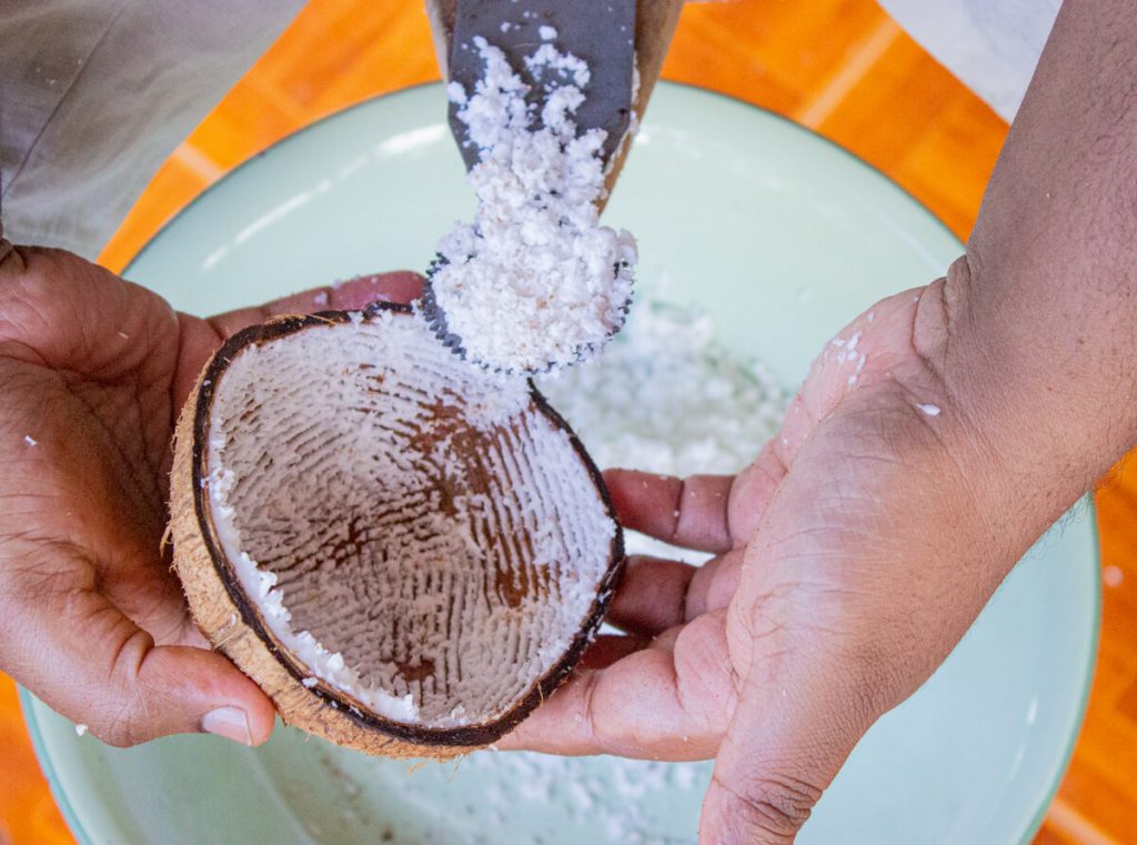 grating brown coconuts